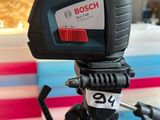 the camera is sitting on a tripod in front of a cake