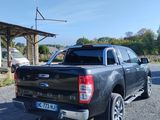 a black pickup truck parked on the side of the road