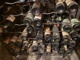 many bottles of wine sitting on a rack in a room