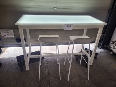 two stools sitting at a table with a price tag on it