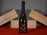 a bottle of wine sitting on a table next to two wooden boxes