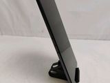 a black tablet on a stand on a white surface