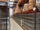 many shelves with boxes on them in a large warehouse