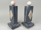 pair of marble bookends with marble balls on top