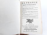 someone is holding a book open to a page with a picture of a dragon