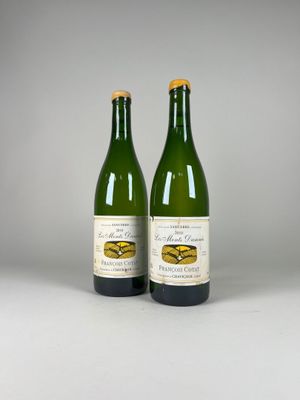 two bottles of wine sitting next to each other on a table