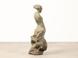an image of a sculpture of a bird sitting on top of a rock
