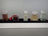 three different types of perfume bottles on a shelf