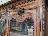 a wooden cabinet with a mirror on top of it