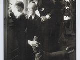 black and white photograph of a woman and two children and a dog