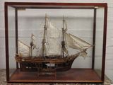 a small model of a ship in a glass case