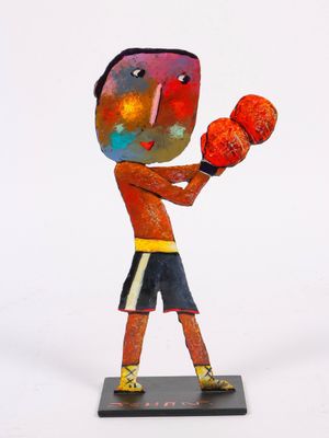 statue of a boy with boxing gloves on a white background