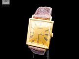 an image of a gold wrist watch with roman numerals