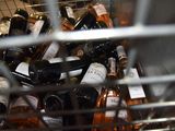 many bottles of wine sitting in a metal basket