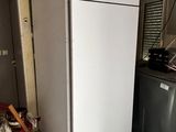 a white refrigerator in a kitchen next to a washer and dryer