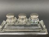 three glass salt and pepper shakers on a clear tray