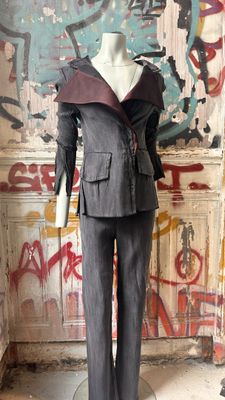 a mannequin in a room with graffiti on the wall