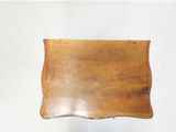 a small wooden tray on a white wall