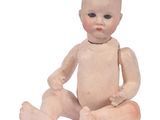 a small doll that is sitting on the ground