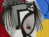 une photo d'un tableau représentant un visage sur un fond rouge et jaune
