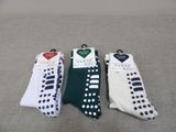 three pairs of socks with black and white polka dots on them