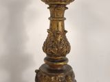 a gold candle that is sitting on a table