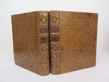 an old book with two pages in it sitting on a white surface