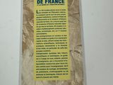 the back cover of a book on a white table with a yellow sticker on it