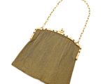 a gold mesh purse with a chain handle