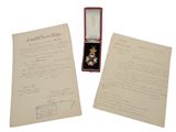 deux feuilles et une médaille sont posées sur une table