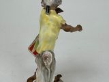 a figurine of a man with a hat on his head