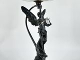 une image représentant une statue d'un ange tenant un oiseau sur un socle
