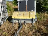 a trailer with a trailer attached to it in a field