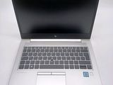 an open laptop computer sitting on top of a white table