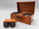 a wooden box that has a pair of binoculars in it