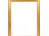 a gold frame on a white wall with a white background