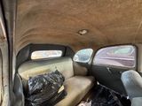 a car with a lot of trash in the back of it