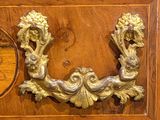a wooden cabinet with a gold decoration on it