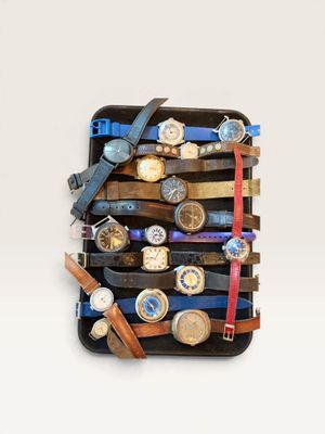 many watches stacked on top of each other in a case