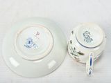 a small cup and saucer sitting on a table