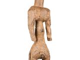 an old wooden statue of a man with a hat on his head