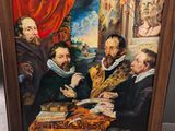 une peinture à l'huile représentant un groupe d'hommes assis autour d'une table