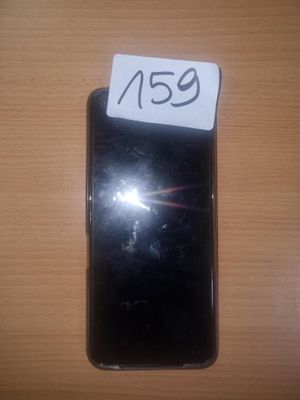 an image of a black cell phone sitting on top of a wooden table