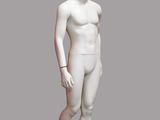 white male mannequin standing in front of a gray background