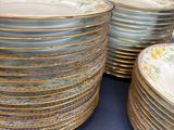 a lot of plates that are stacked up on a table