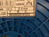 a blue spool with a label on it sitting on a table