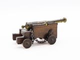 an old wooden cannon with a chain attached to it on a white surface