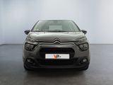 the front of a grey citrole parked in a white room