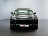 the front of a black porsche cayen is parked in a white room