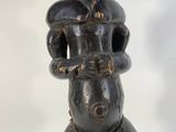 an image of a wooden sculpture of a woman holding a baby